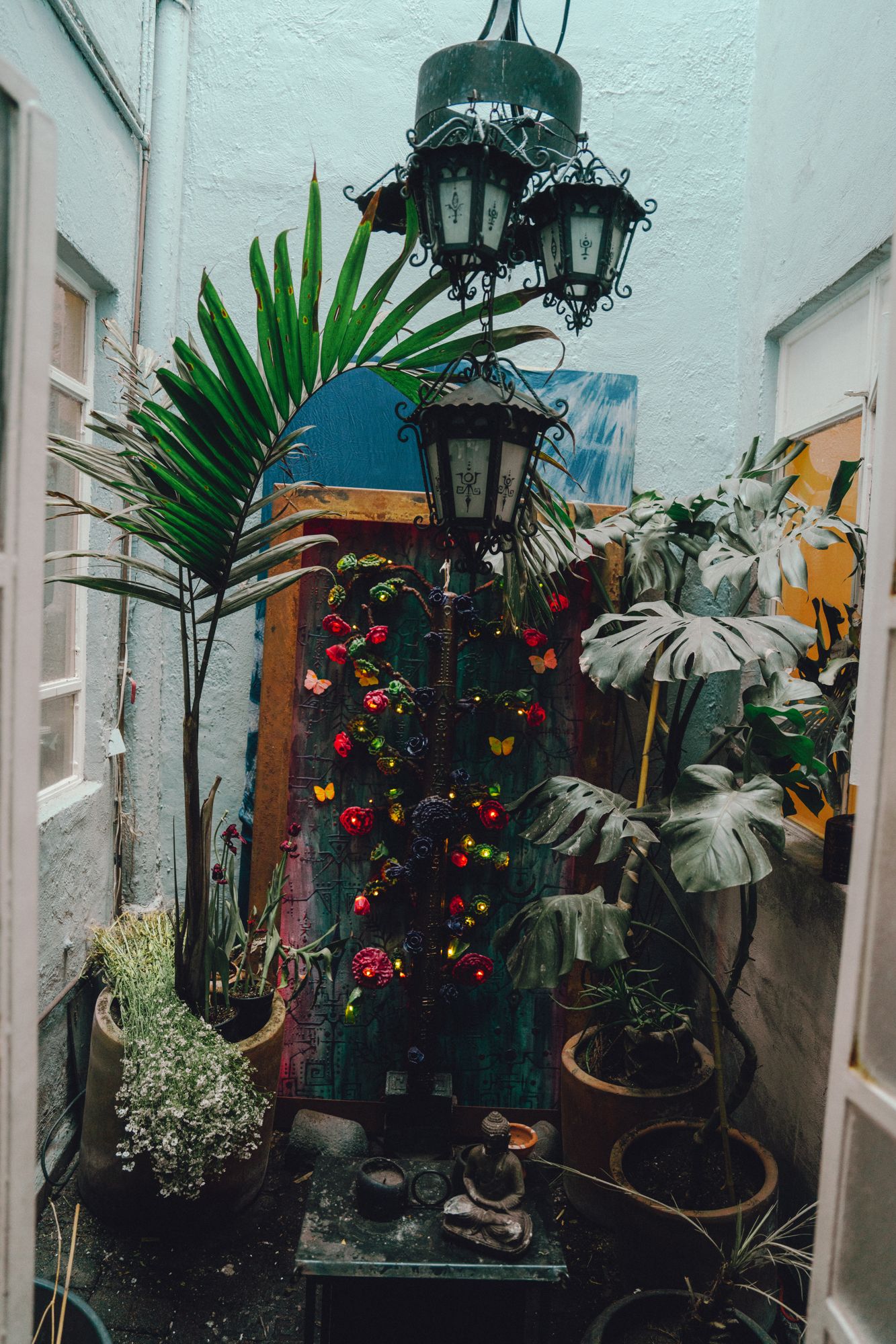 Árbol installed in a lantern-lit passage