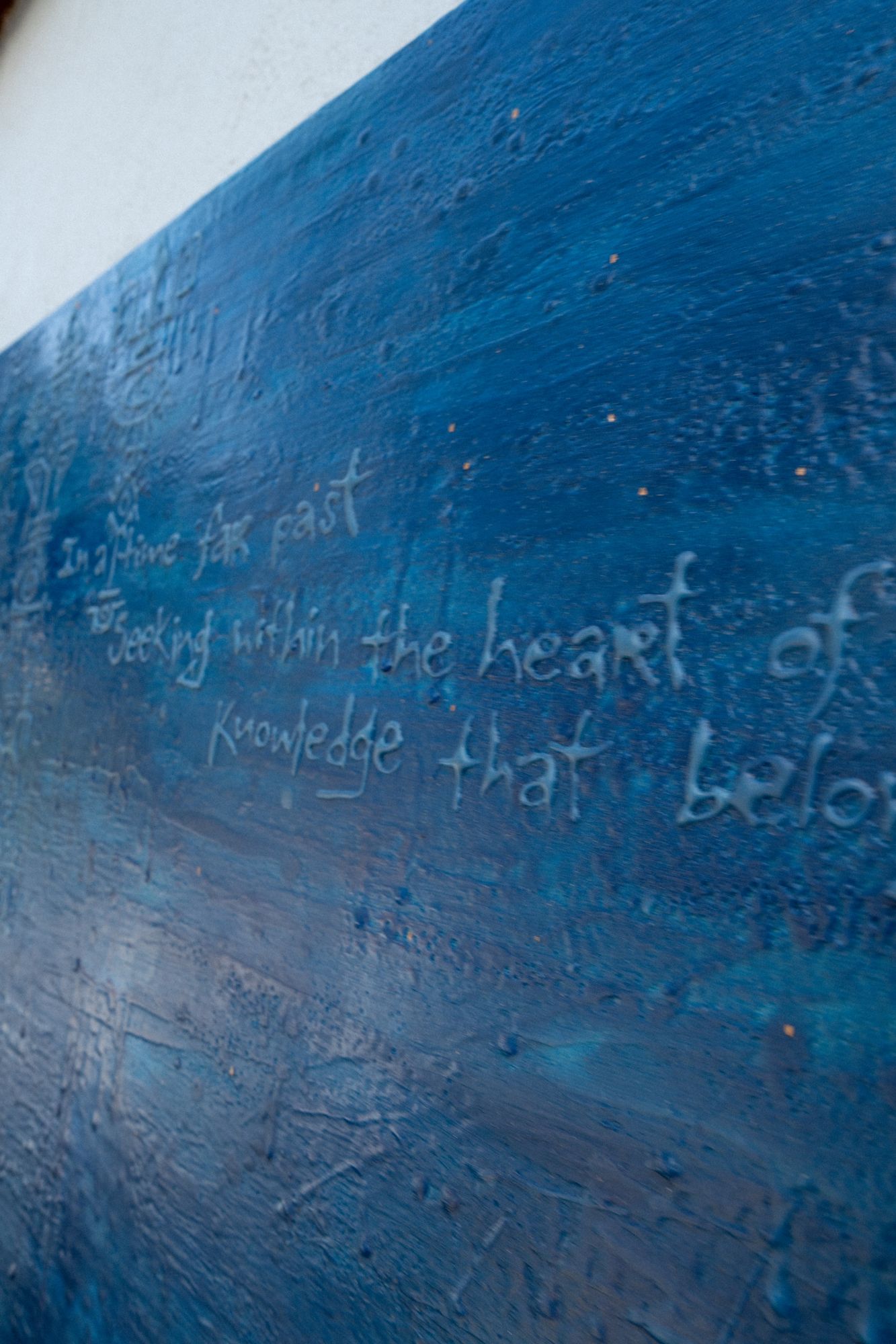 Inscribed text across the blue surface