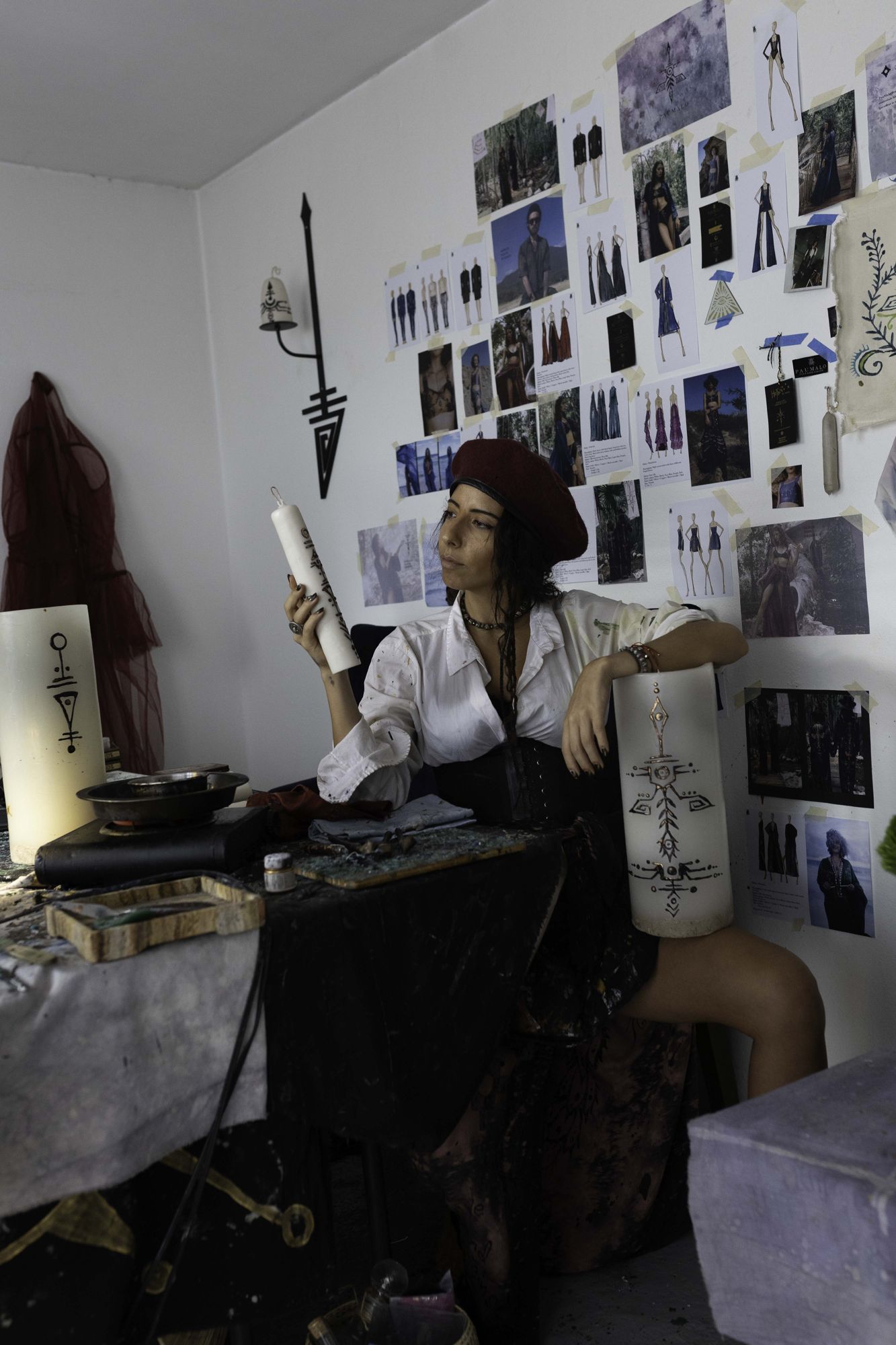Pau at her studio desk beneath the archive wall